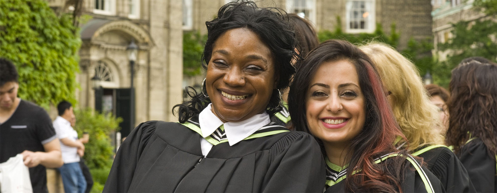 Two OISE students smiling after convocation. 