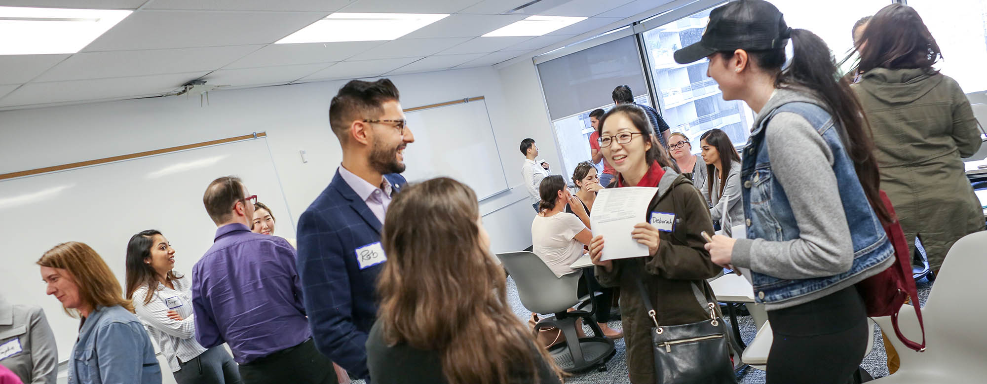 A group of students attending an orientation. 