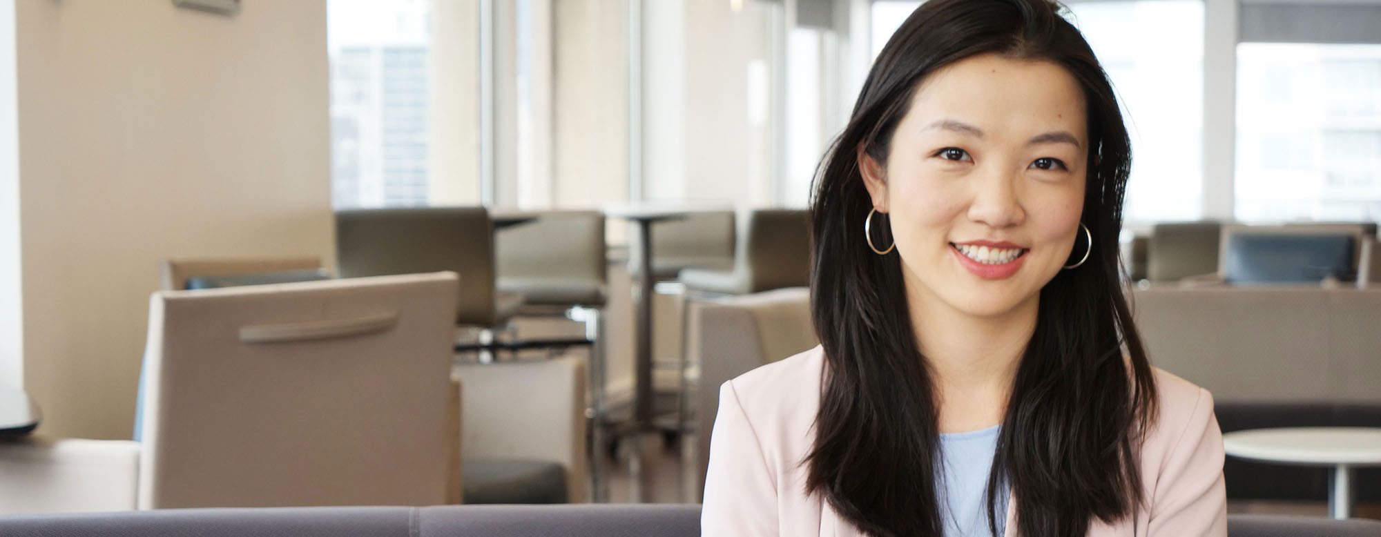 A student smiling and looking directly at a camera. 