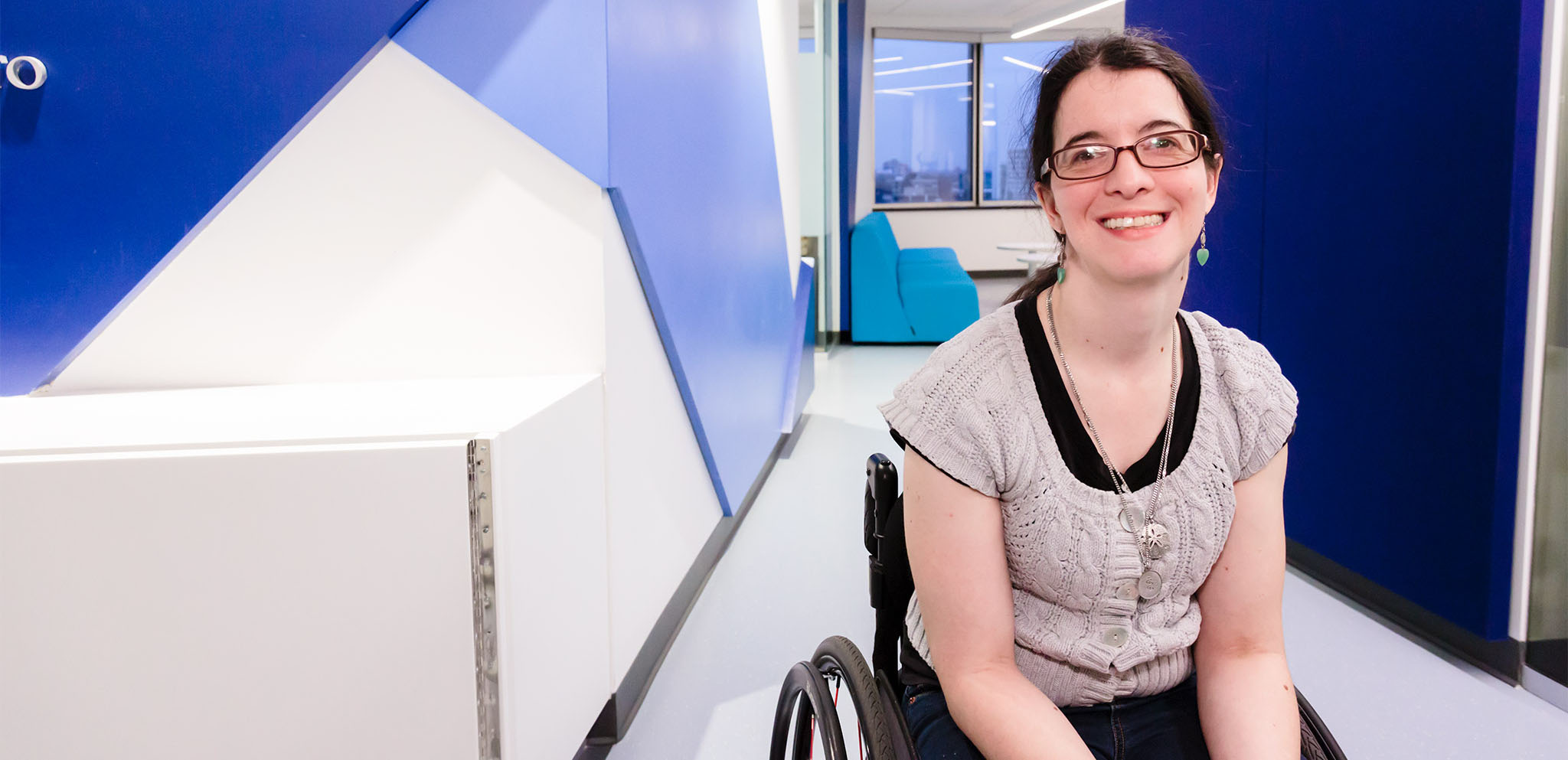 A student smiling in the OISE Registrar's Office.