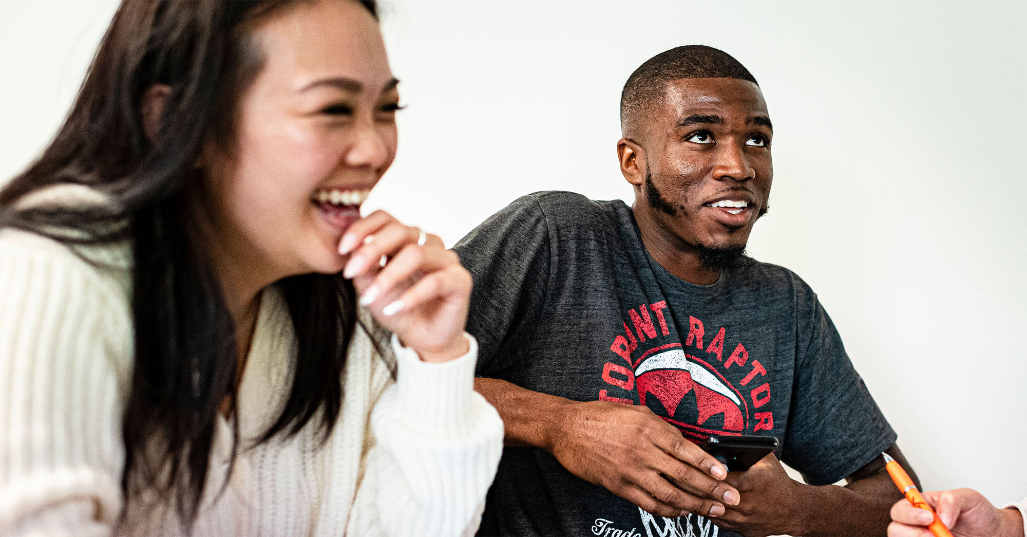 Students talking and listening in a classroom.