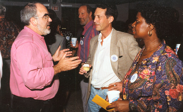 People talking at an OISE event - Archive photo.