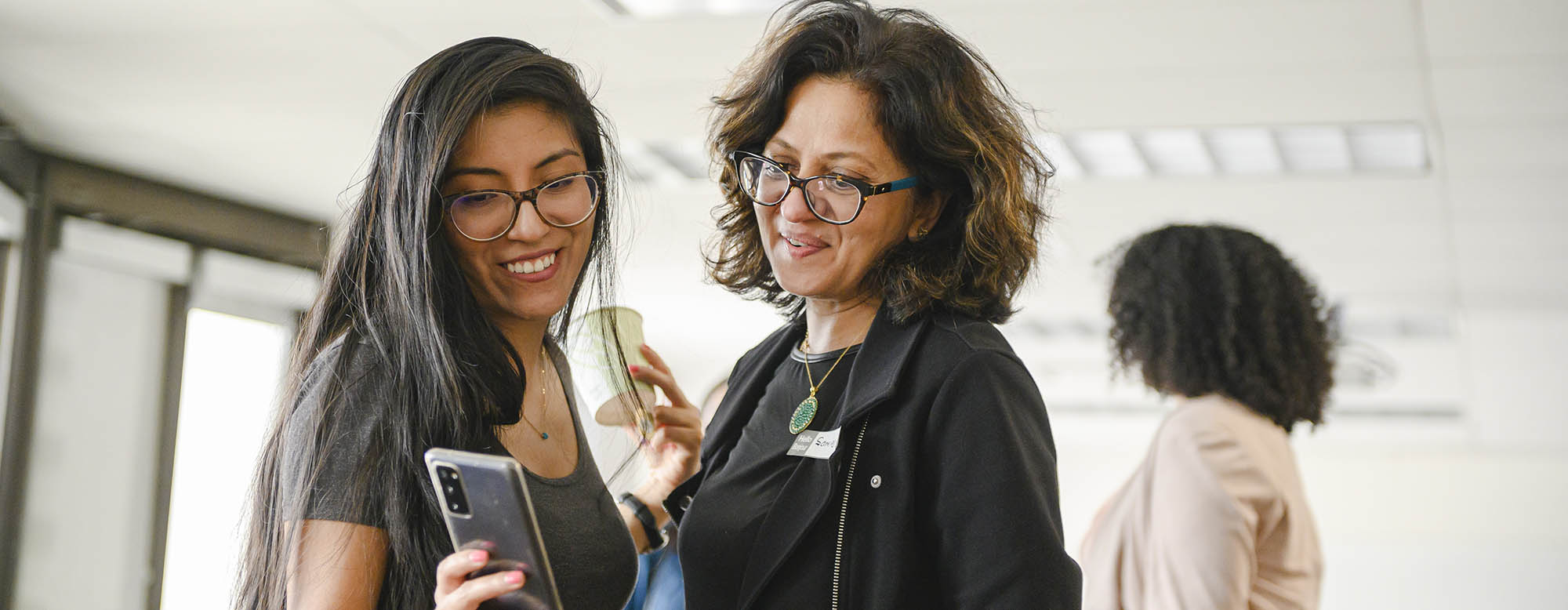 Two students chatting at OISE Orientation. 