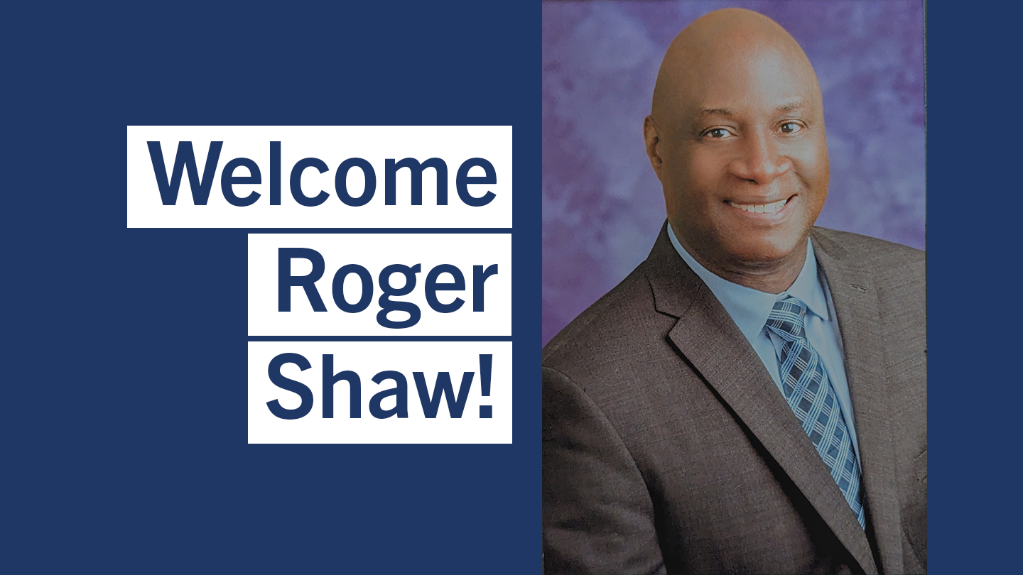 Headshot of Roger Shaw, who is smiling toward the camera. Roger is wearing a suit and tie. The words "Welcome Roger Shaw!" can be read to the left of Roger.