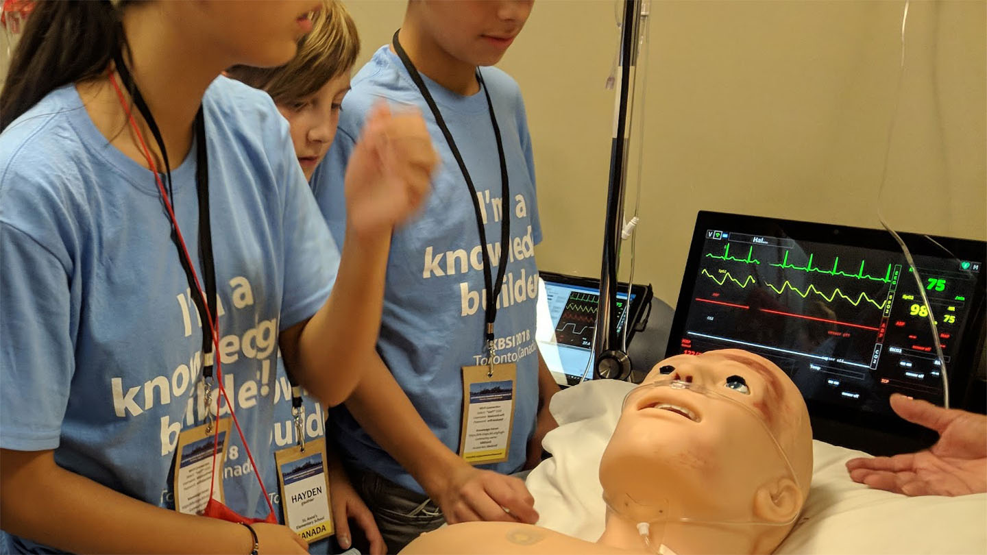 Three students working with.