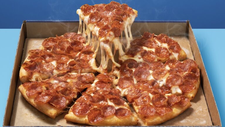 Pepperoni pizza in a box on a blue table