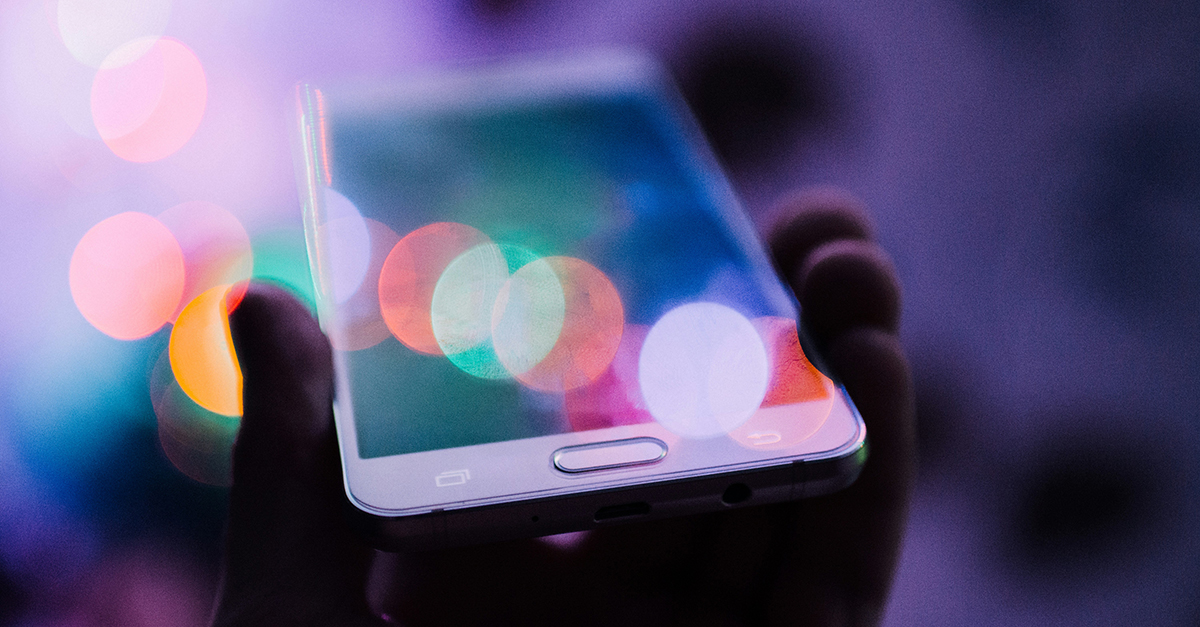 A phone with a colourful lens flare.