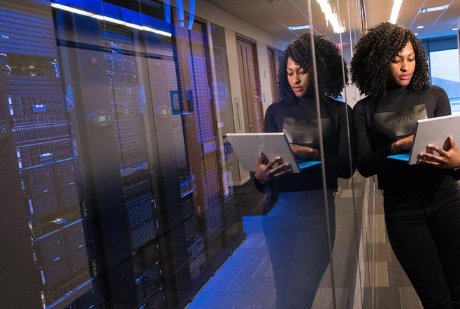 Person standing by servers in the OISE building