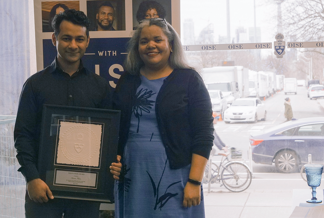 Education Commons' resident Audio Visual and Business Solution Architect, Azeem Khan, holds his Award plaque with OISE Dean, Professor Erica Walker.