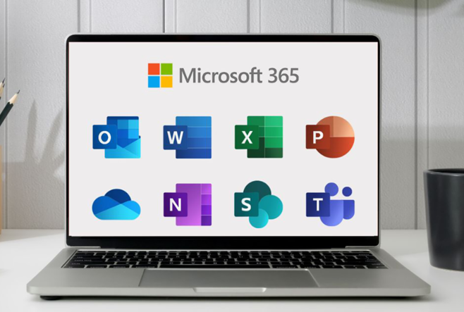 A silver laptop is sitting on white desk. On the screen, logos for different Microsoft 365 apps are visible in two rows: Outlook, Word, Excel, and Powerpoint in the top row, and OneDrive, Notes, Sharepoint, and Teams in the bottom row.