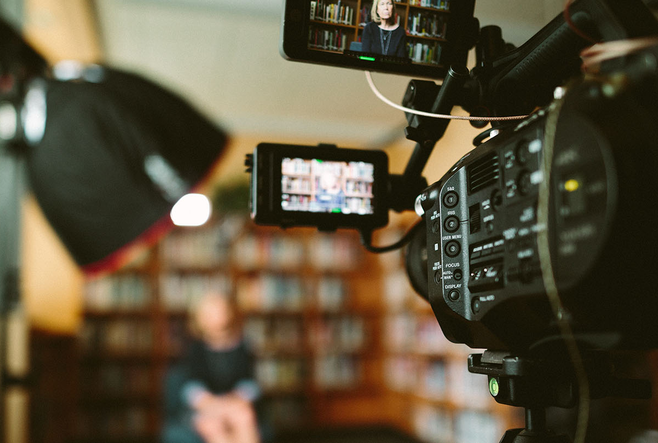 A person being recorded using a video camera.