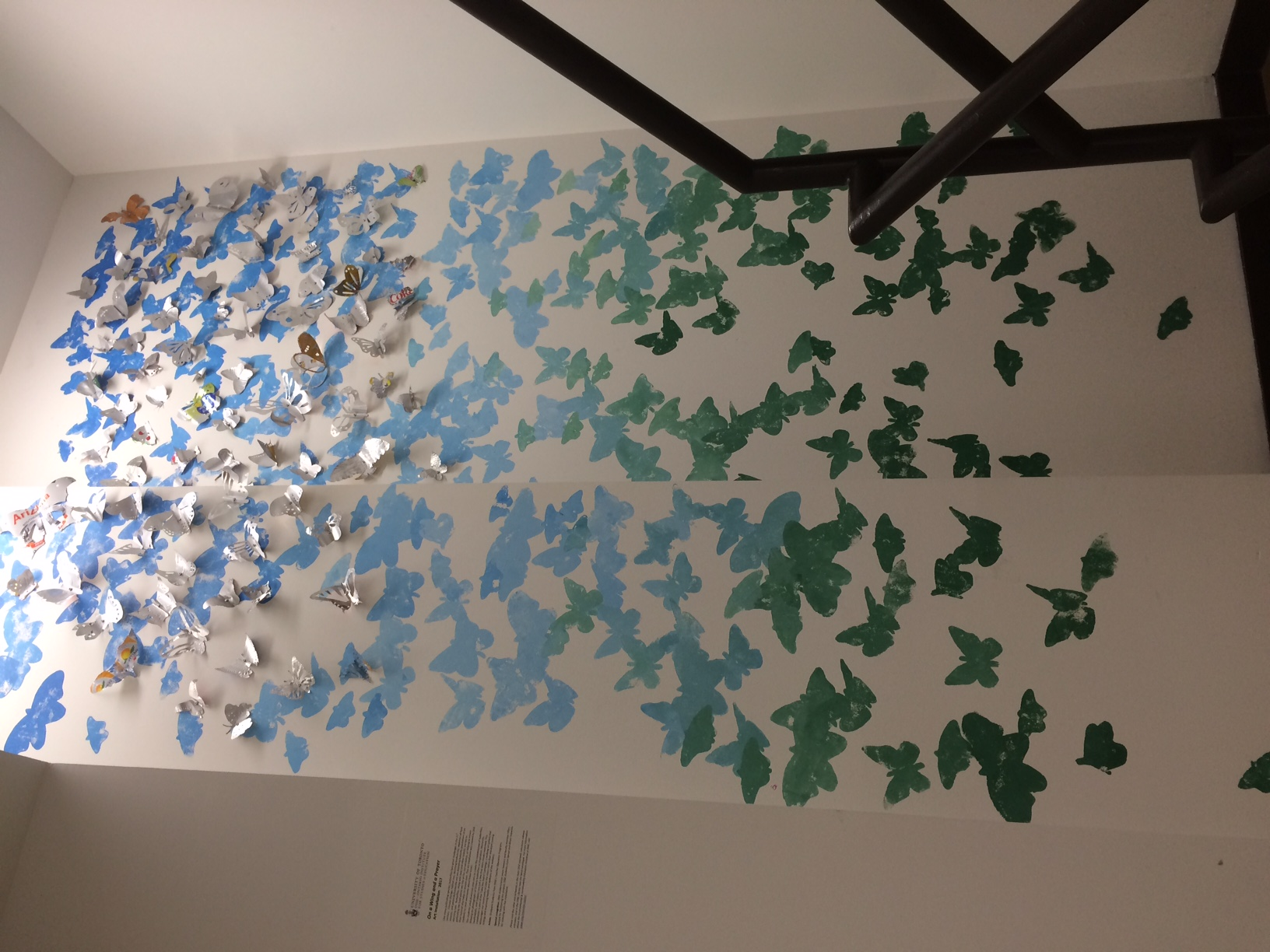 tin can butterflies art installation on wall