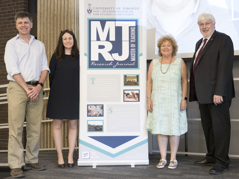 CTL faculty members next to the MTRJ sign at a research conference