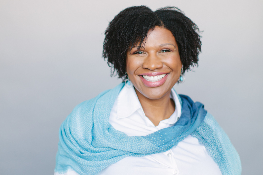 Denise Dwyer is wearing a blue scarf and smiling.