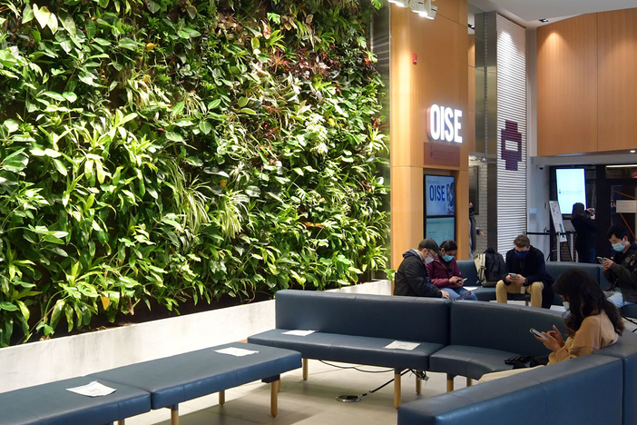 Students seated in the OISE lobby.
