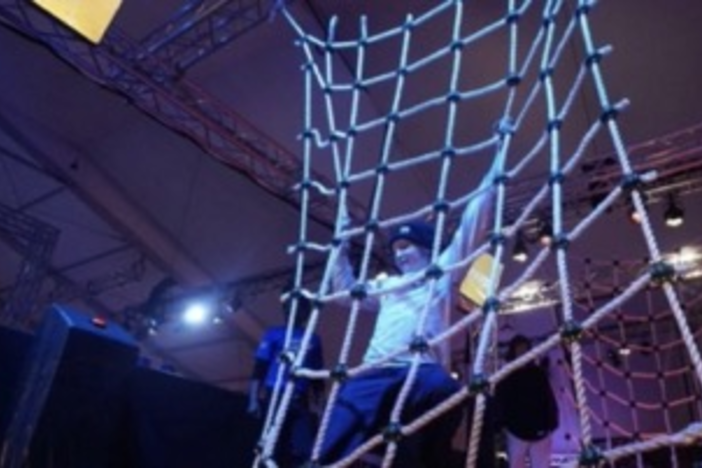 Kid climbing up ropes in an entertainment centre