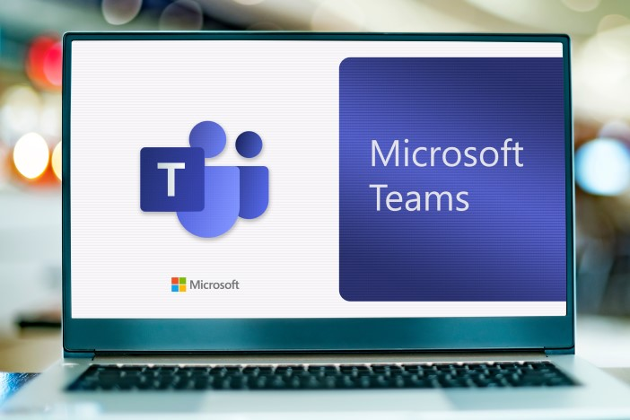 A laptop is open, showing the Microsoft Teams app on its display.
