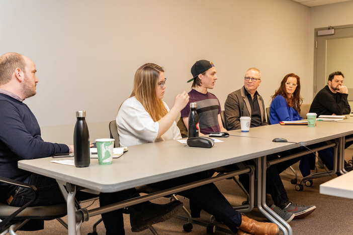 The panelists at the table at the event