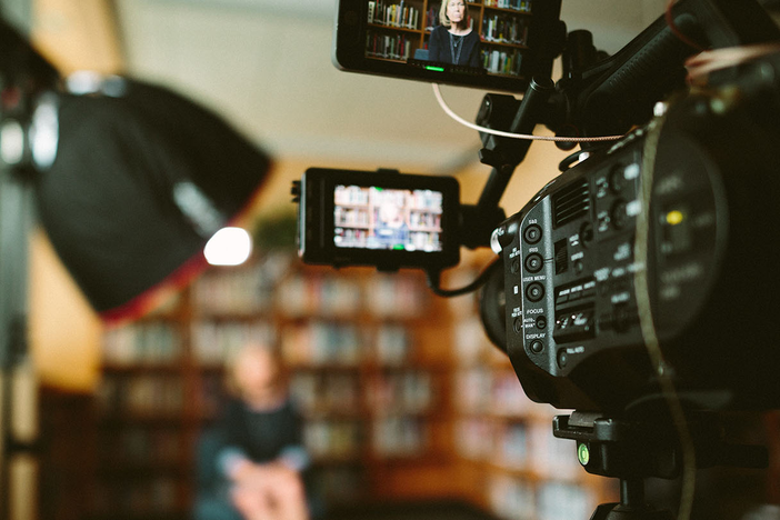 A person being recorded using a video camera.