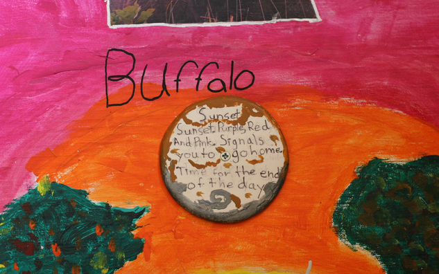 pink orange and green painting with a circle in the middle and the word Buffalo on the top center.