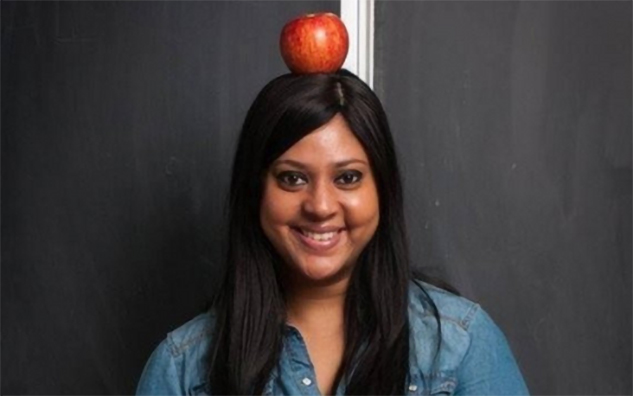 Fariah Chowdhury with an apple on her head.