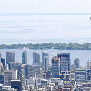 Toronto's cityscape. CN Tower and Lake Ontario in the background, buildings in the foreground.