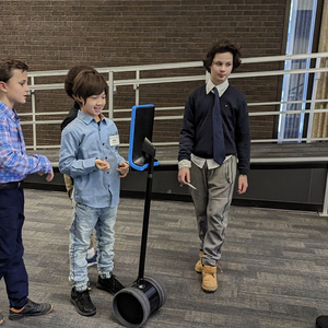 Four students and a Faculty member interacting with DAZEE the Robot at OISE.