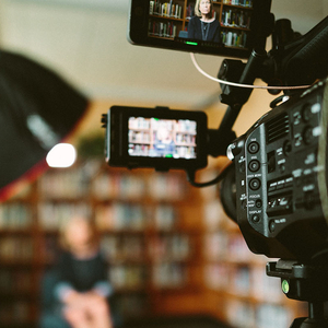 A person being recorded using a video camera.