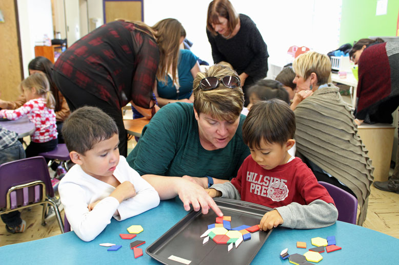 Donald Young educator Laurel Armstrong plays Cookie Sheet Symmetry with students.
