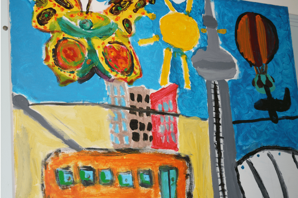 A colorful child-like painting featuring a butterfly, a sun with rays, a cityscape with tall buildings, a streetcar, the CN Tower, a hot air balloon, and a stadium against a blue sky.