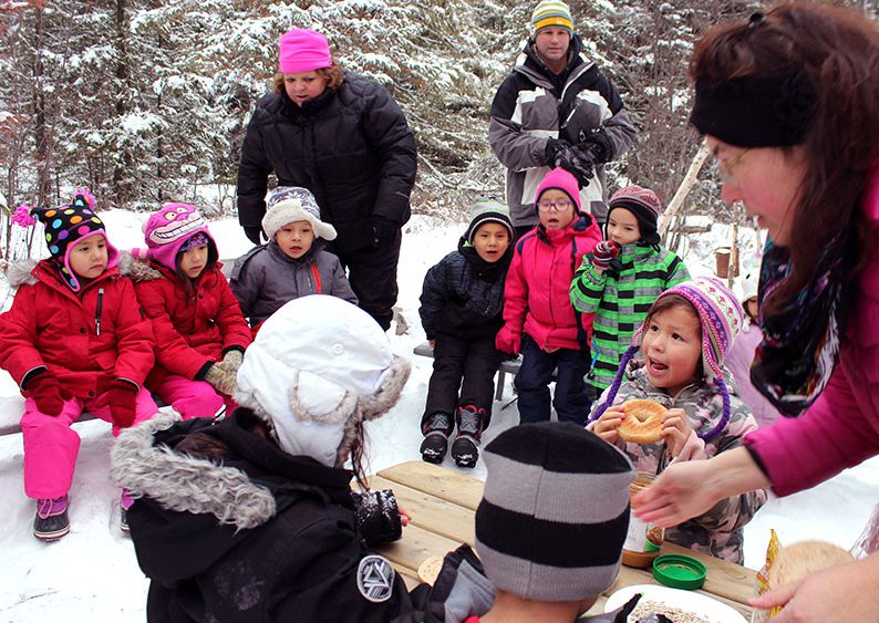 Students look on as their classmates prepare the bird food