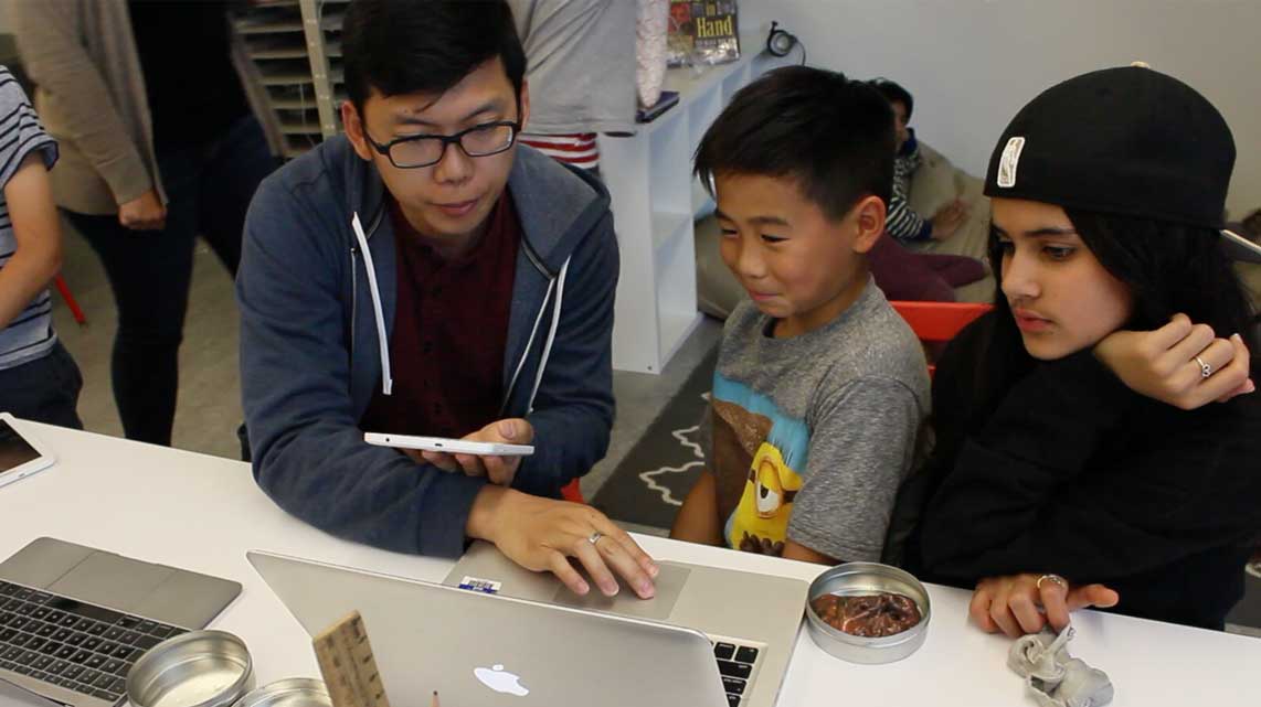 JICS Technology Teacher Nick Song helps a student code