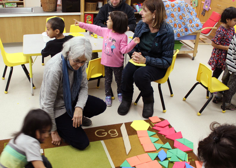 Julie Comay and Joan Moss visit with students in class