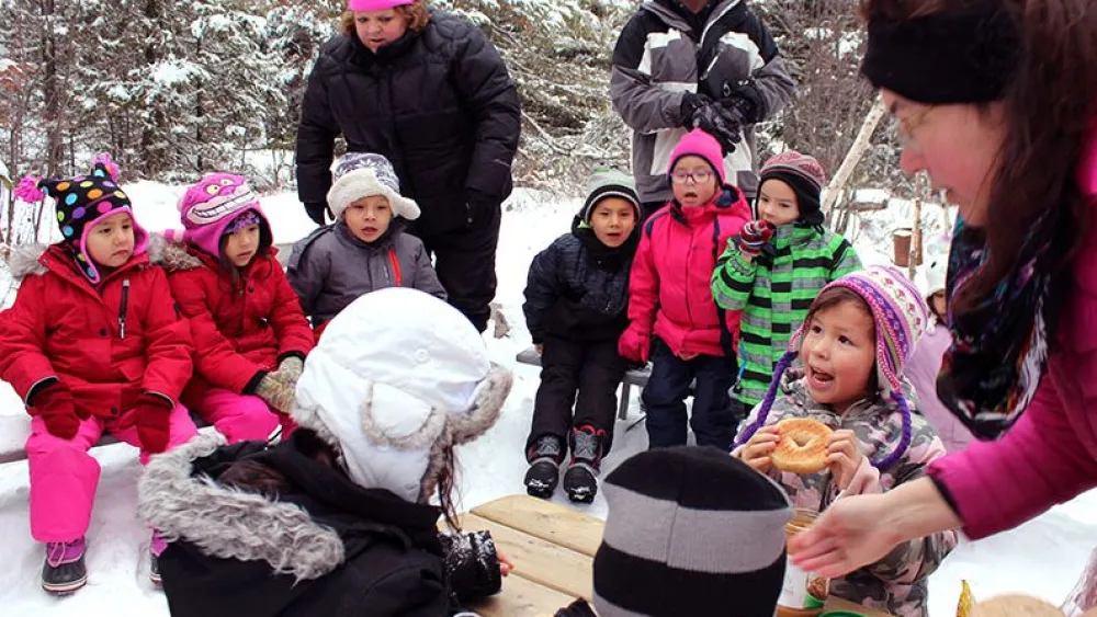 Students look on as their classmates prepare the bird food