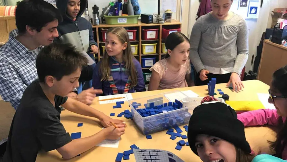 Teacher leads an algebra lesson using a spatial approach to illustrate growing patterns.