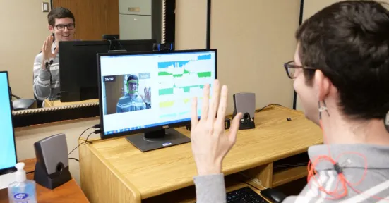 A person using iMotions and waving.