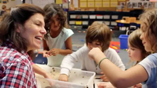A teacher speaking to children.