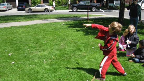 A kid throwing a paper plane into the air