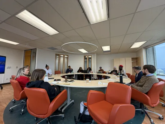 A group of people seated around a round table