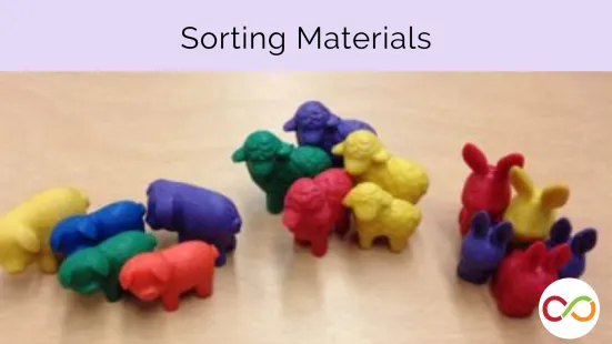 A bunch of different coloured animal toys grouped into piles with a title that reads, "Sorting Materials".