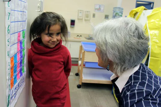 Bev Caswell and a Pegamigaabo Kindergarten student look at the shoe graph which is placed at students’ eye level for easy access.