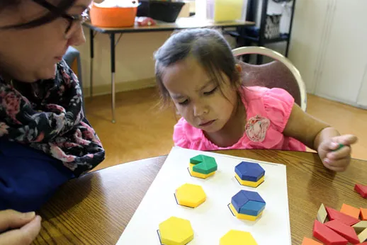 Pegamigaabo Kindergarten teacher Caitlyn Lorentz works one-on-one with a student composing and decomposing 2D shapes.