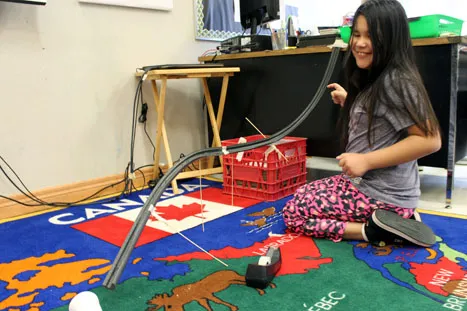 An Onigaming student revises the design of her "roller coaster."