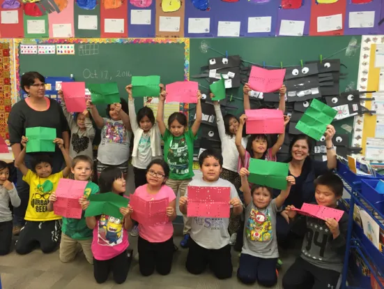 Jane’s class reveals where the hole punches are when the paper is unfolded.