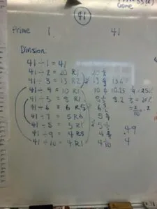 Equations written on a whiteboard in blue marker.