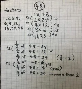 Factors of the number 48 written on a piece of paper.