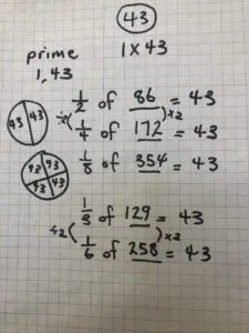A bunch of equations written on a piece of grid paper in black marker.