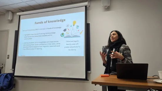 Presenter in classroom discussing the 'Funds of knowledge' concept.
