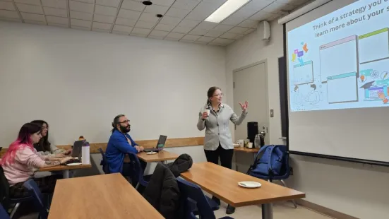 Classroom with students and a presenter showing a slide about learning student strategies.