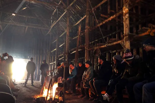 People sitting around fire.